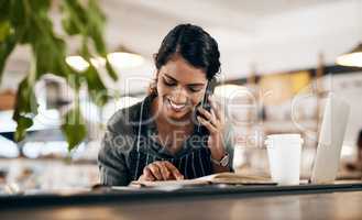 Small business success is on the line. a young woman using a smartphone while working in a cafe.