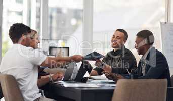 Please take a look at this new proposal. a group of businesspeople having a meeting in an office.