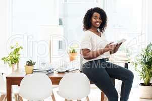 Efficiency is so important to me. Portrait of a young businesswoman using a digital tablet in an office.