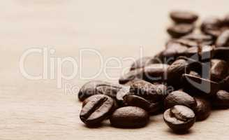 Life is hard, coffee helps. Still life shot of coffee beans on a wooden countertop.