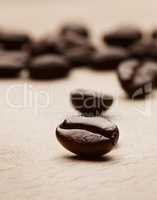 All you need is freshly brewed coffee. Still life shot of coffee beans on a wooden countertop.