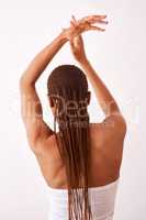 Long braids dont care. Studio shot of a woman with braids posing with her back towards the camera.