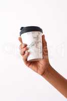 A coffee will make all the worries go away. Studio shot of an unrecognizable woman holding a reusable coffee cup against a white background.