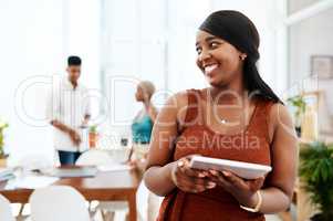 A great device to store your design portfolio. a young businesswoman using a digital tablet in a modern office.