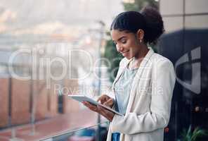 Modern business woman on a tablet during a work break alone outside. Smiling corporate worker looking at web and social media posts on a balcony. Female employee on a digital device with copyspace