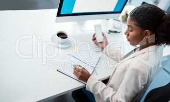 Entrepreneur, secretary and admin assistant holding phone while writing down appointments, schedule and business contacts at her desk. Professional woman doing online research and making notes