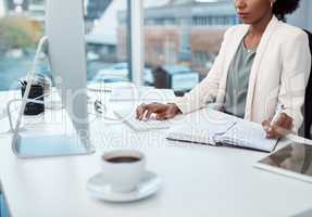 Writing notes, typing on a computer and working at her desk with a corporate and professional business woman. Manager, boss or CEO scheduling appointments in her diary and planning for the future