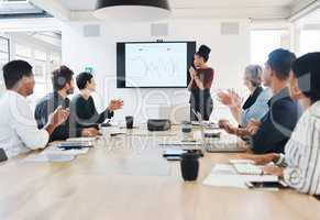 Nothing better than having your team backing you. a group of businesspeople clapping during a meeting in a modern office.