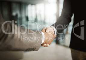 A professional handshake after an interview meeting for a company in a modern corporate office. Formal executive businessmen shaking hands after a successful collaboration leading to a job promotion