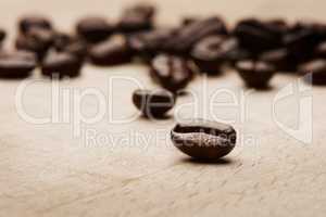 Coffee brings out the best in us. Still life shot of coffee beans on a wooden countertop.