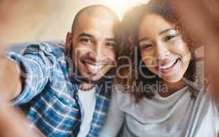 Smiling couple taking selfies as home owners, bonding together or enjoying new real estate purchase. Portrait of a happy man and woman celebrating and capturing memory picture as home investors