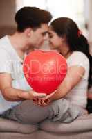 Valentines day done right. an unrecognizable young couple kissing while holding a heart-shaped balloon on valentines day.