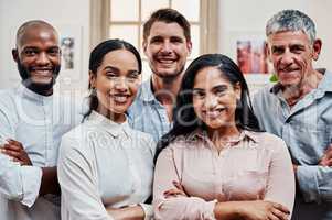 The way to success is with teamwork. Portrait of a group of confident businesspeople working in a modern office.