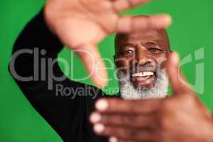 Put that smile out there for people to fall in love with. Studio shot of a senior man forming a finger frame in front of his face.