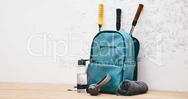 Get your gear together, weve got a game to play. a sports bag and other items in an empty squash court.