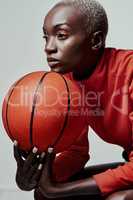 Better be ready for what shes about to bring. Studio shot of an attractive young woman playing basketball against a grey background.