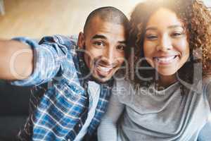 Happy couple taking selfies as home owners, bonding or enjoying new real estate purchase. Portrait of smiling or proud man and woman celebrating and capturing memory picture as home investors