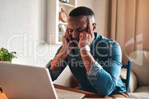Stress, pain and headache while working remote on laptop from home office, freelance man annoyed and under pressure. Frustrated male suffering from a migraine, pressure from workload or a deadline