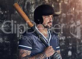 In a league of his own. a young man holding his bat at a baseball game.