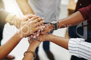 Business people hands stacked showing unity, teamwork and collaboration gesture for a project goal at a team meeting. Group closeup of corporate workers joining, working together and standing united