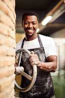 The best bread is made right here. a confident young man working in a bakery.