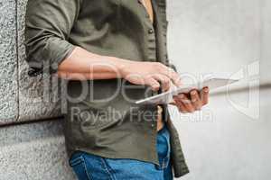 Stay connected with the convenience of wireless tech. a businessman using a digital tablet against an urban background.