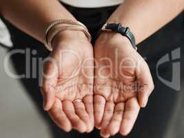 Please contribute if you are able to. Closeup shot of an unrecognisable businesswoman standing with her hands cupped together.