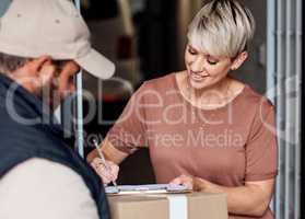 Your delivery will always arrive on time. a young woman signing for a delivery from the courier.