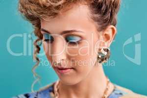 Get dressed, put on some makeup and add some bling. Studio shot of a beautiful young woman wearing a 80s outfit.