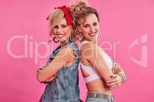 We bring the funk. Studio shot of two beautiful young women styled in 80s clothing.