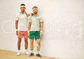 Theres nobody like a squash buddy. two confident young men standing together at a squash court.