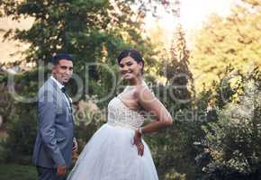 Look stunning on their special day. a young couple posing outside on their wedding day.