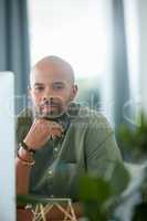 Put in the work, itll be worth it. a young businessman sitting behind a computer in his office.