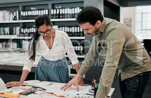 Collaboration has always worked for them. two young architects working together in a modern office.