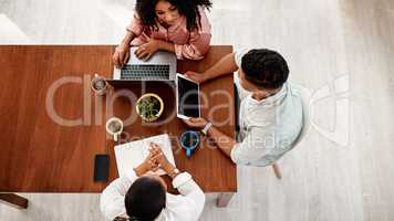 Stick together to stay on top of things. High angle shot of a group of young businesspeople having a meeting in a modern office.