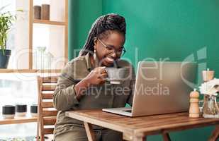 Welcome to the age of the freelancer. a young woman having coffee and using a laptop at a cafe.