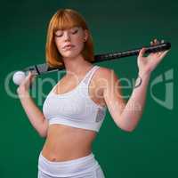 Hockey runs in my blood. an attractive young sportswoman standing and posing with hockey equipment against a green studio background.