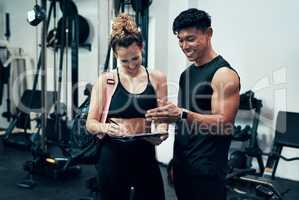 Just fill in this form then well get started. a sporty young woman talking to a fitness trainer at the gym.