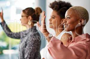 I wanna ask something please. a group of attractive young businesswomen raising their hands to ask a question during a conference.