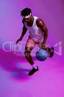 I play the game and I play it well. Purple filtered shot of a sporty young man playing basketball.