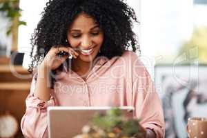 Automating work tasks with the ease of smart apps. a young businesswoman using a digital tablet in a modern office.