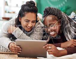 Spend your time with people who make you laugh. two young women using a digital tablet together on the floor at home.