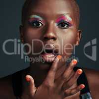 Be the kinda girl who wears whatever color she wants. a beautiful woman wearing colorful eyeshadow while posing against a grey background.