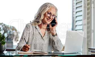 Yes I do have that in my records. an attractive senior businesswoman taking a phonecall while working from home.