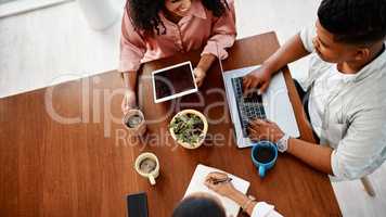 Teamwork is their number one tool. High angle shot of a group of young businesspeople having a meeting in a modern office.