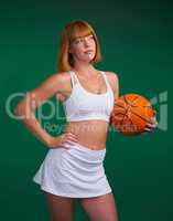 I didnt choose basketball, it chose me. an attractive young sportswoman standing alone and holding a basketball against a green background in the studio.