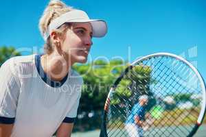 Practice with a purpose, play with a passion. an attractive young female tennis player playing together with a male teammate outdoors on a court.