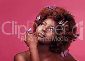 Should I make this my signature look. Studio shot of a beautiful young woman posing topless with butterflies in her hair against a purple background.