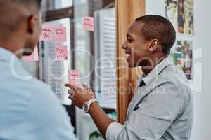 A grand get it done plan. two young young businessmen having a brainstorming session in a modern office.