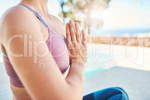 Creating her own calm. an unrecognizable woman practicing yoga outdoors.